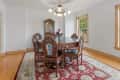 Before: Dining room with white walls, traditional furniture, and traditional chandelier