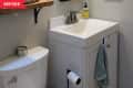 Before: Bathroom with beige walls and white vanity