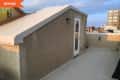 Before: roof deck with tan stucco finish on walls