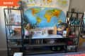 Before: A large shelving unit in front of a map