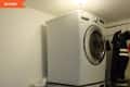 Before: Stacked washer/dryer in corner of laundry room