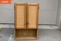 Before: plain wood cabinet with two doors and an open shelf on the bottom