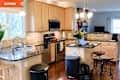 Before: kitchen with brown cabinets and small island