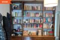Before: Shiny brown bookcase holding books