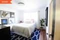 Before: bedroom with blue rug and gallery wall