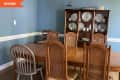 Before: Dining room with blue walls and antique furniture