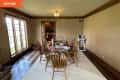 Before: Dining room with brown trim and beige grasscloth wallpaper