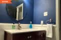Before: Blue bathroom with brown vanity