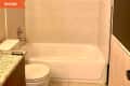 Before: white tub next to white toilet