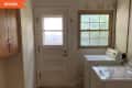 Before: a laundry room with two machines next to a window