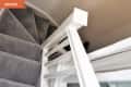 Carpeted staircase with white wooden railing, viewed from above, labeled "Before" in orange.