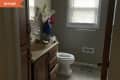 Before: Dated beige bathroom