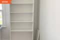 Before: an empty white bookshelf