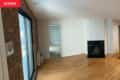 Before: Empty living room with exposed brick wall and fireplace in corner
