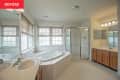 Before: the full view of a bathroom with two sinks, a tub, and a separate shower