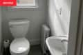 Before: a white toilet and sink in a white bathroom