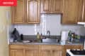Before: Kitchen with yellow walls and cathedral-style cabinetry