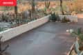 Brown flooring painted on outdoor patio before renovation.