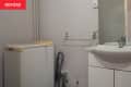 Before: Basic grayish white bathroom with washing machine in corner