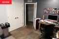 Before: A gray room with a desk and three white doors