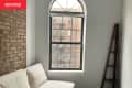 Before: Small living room with exposed brick