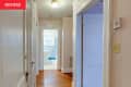 Doorways line a light pink painted hallway before renovation.