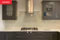 Grey cabinets in kitchen before renovation.