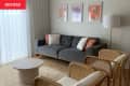 Art prints above sofa in living room before renovation.