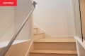 white plan stairwell with light wood floors