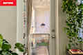 White door with clear glass in the middle and plants on either side of the room