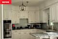 White cabinets in kitchen before renovation.
