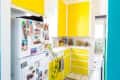 A kitchen with yellow cabinets and drawers