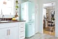 A small kitchen with a bright blue SMEG fridge