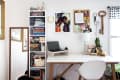 Home office with a white desk, laptop, bookshelves, wall art, and decor items like a lamp and plants.