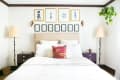 Artwork in matching frames arranged neatly on a bedroom wall