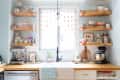 Kitchen with wooden shelves displaying colorful mugs, teapots, and bowls, a coffee maker, and a mixer on the counter.