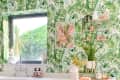 Kitchen with tropical leaf wallpaper, window, white countertop, kettle, and decorative shelf with plants and pink accents.
