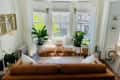 Leather sofa facing bay window in living area