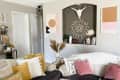 Bohemian styled living room with two white sofas and a ton of throw pillows