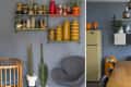 Dining room with blue walls, vintage fridge, wooden table, colorful ceramics, and hanging pendant lights.