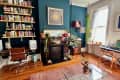 A fireplace and desk on a blue wall