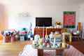 View of white living room with colorful accessories.