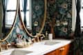 Floral wallpaper in bathroom with wooden vanity topped with white stone surface. Vanity surface in lined with perfume collection.