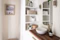 Apartment bathoom with lots of white, natural wood, natural colors, natural fiber textiles