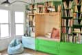 Colorful reading nook with pom poms surrounding reading seating nook.