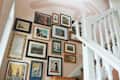 stairway with pale blush wall paint designs and gallery wall