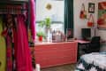 Pink dresser in colorful bedroom.
