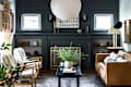 blue living room with brown leather couch and white paper lantern
