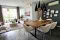 White and gray walls and dining table with boucle chairs