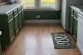 green kitchen with green cabinets and white counter and trim